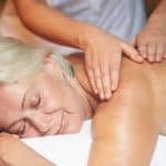 Older woman receiving massage to her back