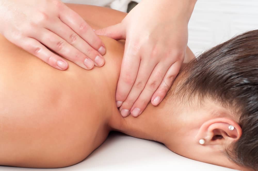 Woman receiving massage to her back