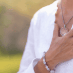 closeup of woman's hand over here heart