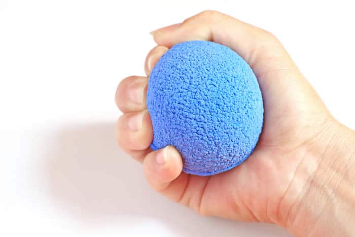 A soft gripping ball is one example of a self care tool for massage therapists.