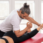 Male massage therapist working on massage client for treatment of sciatic pain
