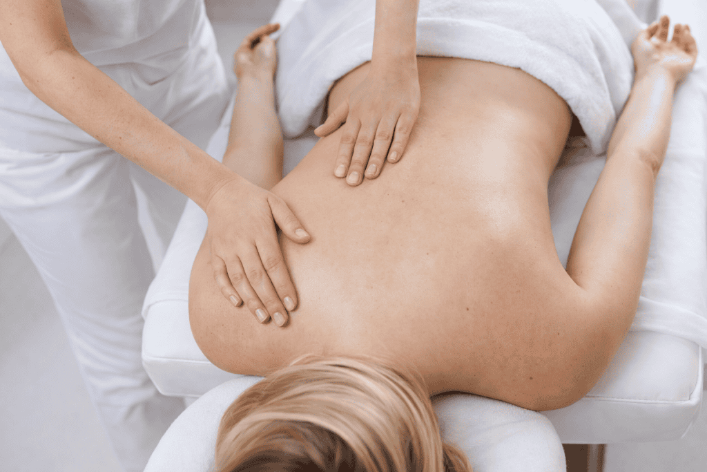 massage therapist performing gentle back massage for autoimmune disease patient
