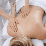 massage therapist performing gentle back massage for autoimmune disease patient